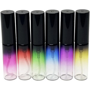 May include: Six glass spray bottles with black caps. The bottles have a gradient color scheme, transitioning from pink to red, green, blue, purple, and yellow. Each bottle has a clear spray nozzle.