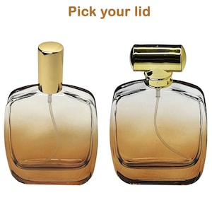 May include: Two glass perfume bottles with gold-colored lids. The bottles have a square shape with rounded edges and a gradient amber color. The text "Pick your lid" is at the top of the image.