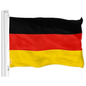 May include: A German flag waving in the wind. The flag is black, red, and yellow.