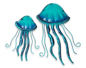 May include: Two teal and blue metal jellyfish sculptures. The jellyfish feature textured caps and long, flowing tentacles. The larger jellyfish is approximately 30 cm tall, while the smaller one is about 20 cm tall. Ideal for wall decoration.