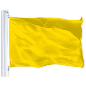 May include: A bright yellow flag waving in the wind. The flag is attached to a white pole.