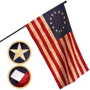 May include: A 3x5 foot American flag with 13 stripes and 13 stars in a circle on a blue field. The flag is made of a weathered fabric and is attached to a black pole. The flag is displayed against a white background.