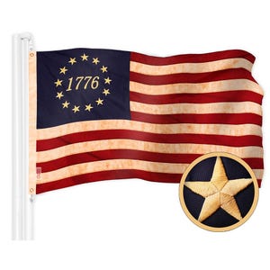 May include: A red, white, and blue American flag with 13 stripes and a blue canton featuring a circle of 13 gold stars and the number "1776" in gold. The flag is waving in the wind.
