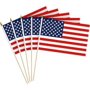 May include: A collection of small American flags, each featuring the stars and stripes design. The flags have a blue field with white stars and red and white stripes. They are mounted on wooden dowels with gold-colored tips.