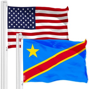 May include: Two flags on flagpoles, the American flag and the flag of the Democratic Republic of the Congo. The American flag is red, white, and blue with stars. The Congolese flag is blue with a yellow star and a red diagonal stripe with a yellow border.