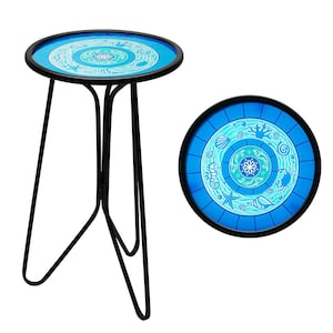 May include: A round side table with a black metal frame and three legs. The tabletop features a blue and white ocean-themed design with starfish, seashells, and seahorses. The table is approximately 20 inches in diameter.