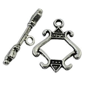 May include: Silver tone toggle clasp with a decorative design. The clasp has a loop on one end and a decorative piece on the other end.