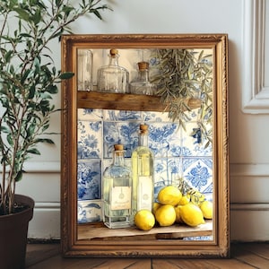 May include: A framed still life featuring glass bottles with cork stoppers, lemons, and a blue and white tile background. The bottles contain a clear liquid, and the lemons are bright yellow. The frame is a warm, golden color, and the overall theme is a kitchen or dining room.