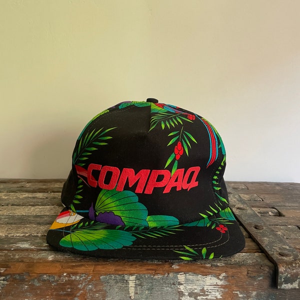 Vintage Compaq computers tropical print five panel cap. One size fits all. Adjustable. Made in the USA.