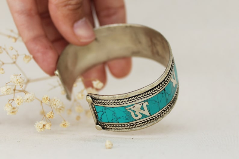 Handmade by artisans from Nepal. SUNITA TURQUESA PULSERA \u2013 Metal bracelet and stones tinted in turquoise with mantra
