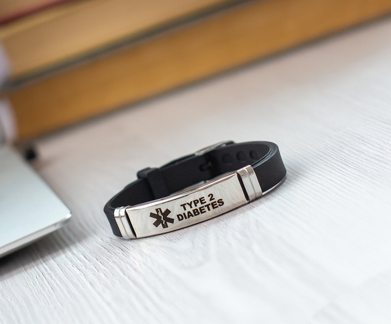 May include: Black silicone bracelet with a silver metal plate engraved with a medical symbol and the text "TYPE 2 DIABETES".