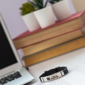 May include: Black silicone medical alert bracelet with a silver metal plate engraved with "TYPE 2 DIABETES".