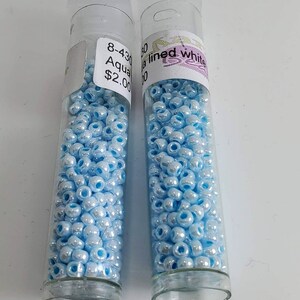Aqua Lined White Pearl Seed Beads (Baby Blue Coloring) approximately 8gr per tube #234