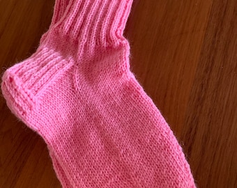 Pink handknitted socks with flower