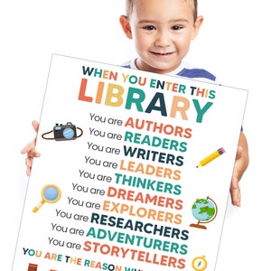 May include: A colorful poster with the text "When you enter this library..." and a list of words describing the roles of library users, including "authors", "readers", "writers", "leaders", "thinkers", "dreamers", "explorers", "researchers", "adventurers", and "storytellers". The poster also includes a picture of a camera, magnifying glass, pencil, globe, and compass.