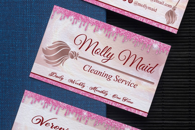 May include: Pink and white business card with a gold glitter design. The card says "Molly Maid Cleaning Service" and "Daily - Weekly - Monthly - One Time".