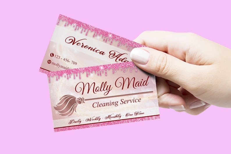 May include: Pink and white business card with a pink glitter border. The text on the card reads "Molly Maid Cleaning Service" and "Daily - Weekly - Monthly - One Time".
