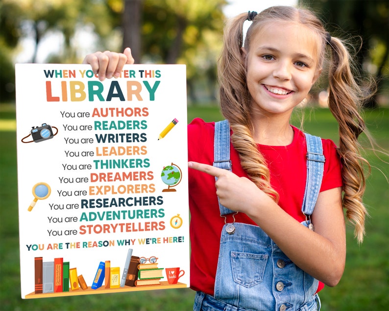 May include: A colorful poster with the text "When you enter this library..." and a list of words describing the people who use the library, such as "authors", "readers", "writers", "leaders", "thinkers", "dreamers", "explorers", "researchers", "adventurers", and "storytellers". The poster also includes the text "You are the reason why we're here!" and a picture of books.