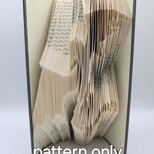 May include: A book art sculpture, folded into a 3D shape, with the text "pattern only" printed below the sculpture.