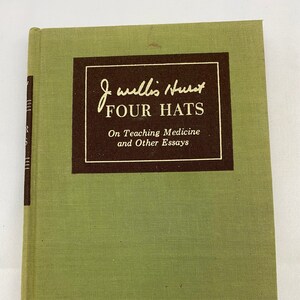 May include: A green hardcover book with a brown title block. The title block reads "J. Willis Hurst FOUR HATS On Teaching Medicine and Other Essays".