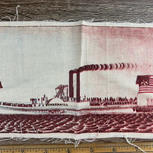 May include: A vintage fabric patch depicting a red and white steamboat with the name "BUNKERHILL" printed on the side. The boat is sailing on a red and white wavy water surface. The boat has a single star flag and an American flag flying from the mast.