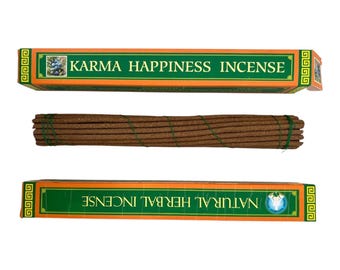 May include: Two boxes of incense with the text "Karma Happiness Incense" and "Natural Herbal Incense". The boxes are orange and green. A bundle of brown incense sticks is in the middle, tied with green string.