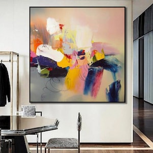 May include: Abstract painting with a colorful, layered design. The painting features shades of pink, blue, yellow, green, and white. The colors are blended together to create a dynamic and energetic composition.