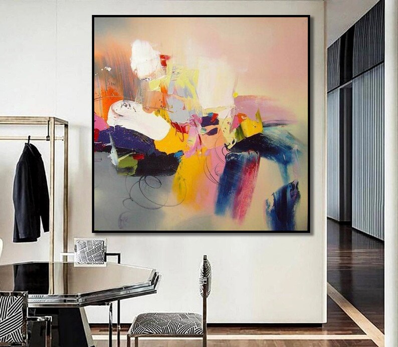 May include: Abstract painting with a colorful, layered design. The painting features shades of pink, blue, yellow, green, and white. The colors are blended together to create a dynamic and energetic composition.