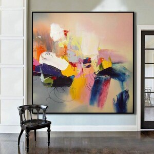 May include: Abstract painting with bold strokes of yellow, pink, blue, and green on a light beige background. The painting has a modern and contemporary style.