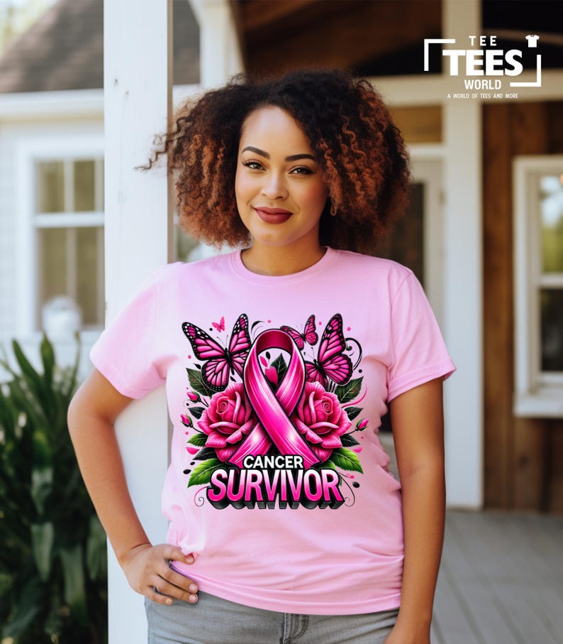 May include: Pink t-shirt with a pink ribbon, butterflies, and roses. The text "Cancer Survivor" is printed on the shirt.