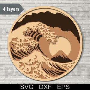 May include: A circular wooden wall art design featuring a layered, multi-coloured image of a large wave crashing over a mountain. The text "4 layers" is visible at the top of the image.