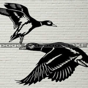 May include: Two black silhouette images of ducks in flight. The ducks are facing the right side of the image. The ducks are against a white brick wall background.