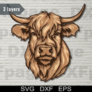 May include: A detailed illustration of a Highland cow's head, in shades of brown. The image is layered, with the text "3 layers" and "SVG DXF EPS" at the top and bottom. The cow has large horns and a shaggy coat.