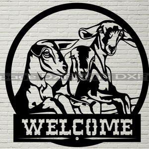 May include: Black metal welcome sign with a circle featuring three goats and the word "WELCOME" underneath.
