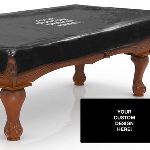 May include: Black pool table cover with a custom design option. The cover is made of a durable material and fits snugly over the table. The table has a traditional design with turned legs.