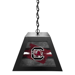 May include: Black pendant light with a chain and a square shade featuring a University of South Carolina Gamecocks logo on a gray and white background.