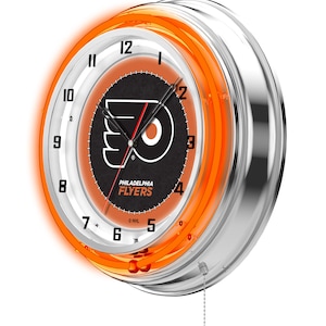 May include: A round, chrome-finished neon clock featuring the Philadelphia Flyers logo. The clock face is black with the team logo and the words "PHILADELPHIA FLYERS". The clock has an orange neon ring and a pull chain.