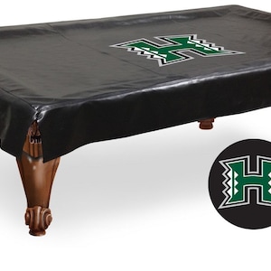 May include: Black pool table cover with a green "H" logo in the center. The logo has a white outline and a patterned design. The cover is made of a durable material and is perfect for protecting your pool table.