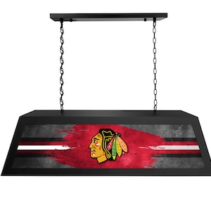 May include: Black hanging light fixture with a red, white, and black Chicago Blackhawks logo on a distressed background.