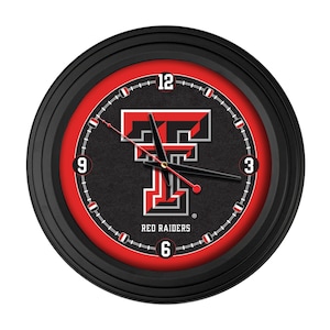 May include: A round black wall clock with a red and black face. The clock features the Texas Tech Red Raiders logo in the center, with the words "RED RAIDERS" below. The clock hands are black.