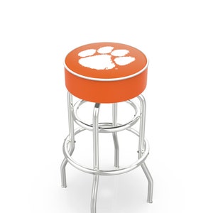 May include: Orange bar stool with a chrome frame and a white paw print logo on the seat.