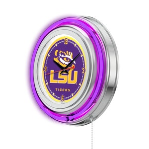 May include: A purple and gold LSU Tigers neon clock with a silver frame and a pull chain. The clock face features the LSU logo and the words "LSU Tigers".