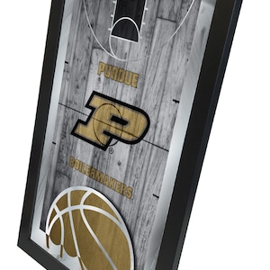 May include: A framed print of a basketball court with a gold Purdue Boilermakers logo and a basketball. The background is a wood grain pattern.