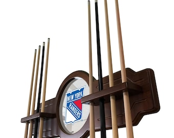 May include: A wooden wall-mounted pool cue rack with a mirror featuring the New York Rangers logo. The rack has six slots for cues and a brown finish.