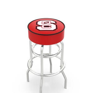 May include: A red and black bar stool with a chrome frame. The round seat features a red background with a white and black logo. The stool has a footrest and four curved legs.