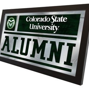 May include: A rectangular wall mirror with a black frame featuring the text Colorado State University and ALUMNI in dark green and white. The design includes a circular ram head logo on the left side against a dark green wood grain background.