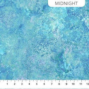 May include: A close-up of a fabric with a marbled design in shades of blue, teal, and hints of purple. The fabric has a textured appearance, with a ruler at the bottom showing measurements in inches. The word "MIDNIGHT" is printed at the top.