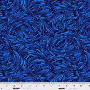 May include: A fabric featuring a repeating pattern of swirling, feather-like shapes in various shades of blue, ranging from deep navy to bright cobalt. A white ruler measuring 12 inches is visible along the bottom edge of the textile.
