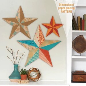 May include: A pattern for making three dimensional wall art stars. The pattern includes three stars in different sizes: 13 inches, 20 inches, and 25 inches. The stars are made of paper piecing and are perfect for holiday decor or your front door.