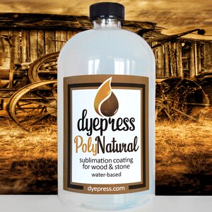 May include: A clear plastic bottle of dye press PolyNatural sublimation coating for wood and stone. The bottle is labeled with the company logo and website address. The bottle is in front of a rustic wooden background.